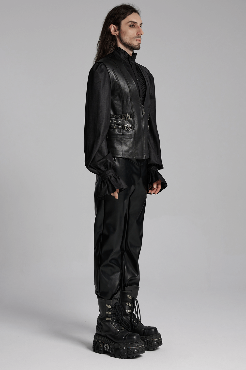 Men's Gothic leather vest featuring buckles and studs, paired with stylish black trousers and bold boots.