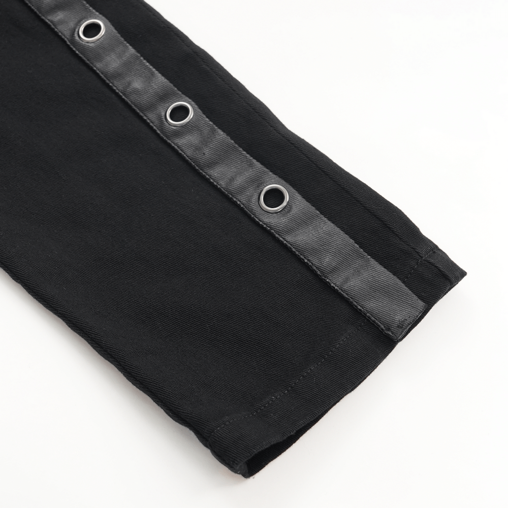 Close-up of black slim fit pants featuring metal eyelets and sleek zipper accents, showcasing punk rock style.