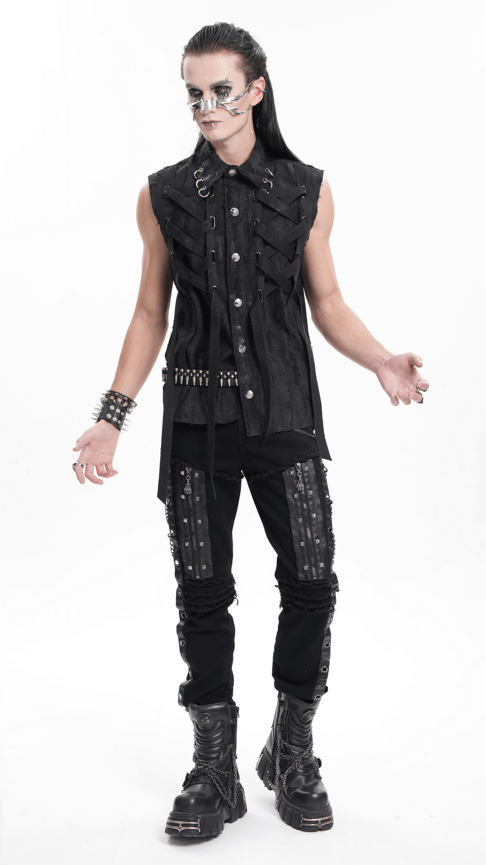 Edgy gothic punk model showcasing sleeveless shirt and slim-fit pants with studs and chains, perfect for alternative fashion.