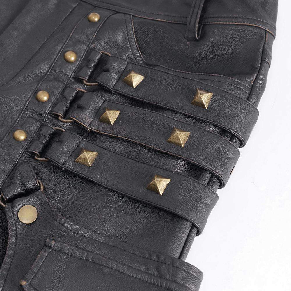 Close-up of men's gothic punk faux leather pants with shiny gold studs and buckles for a bold style statement.