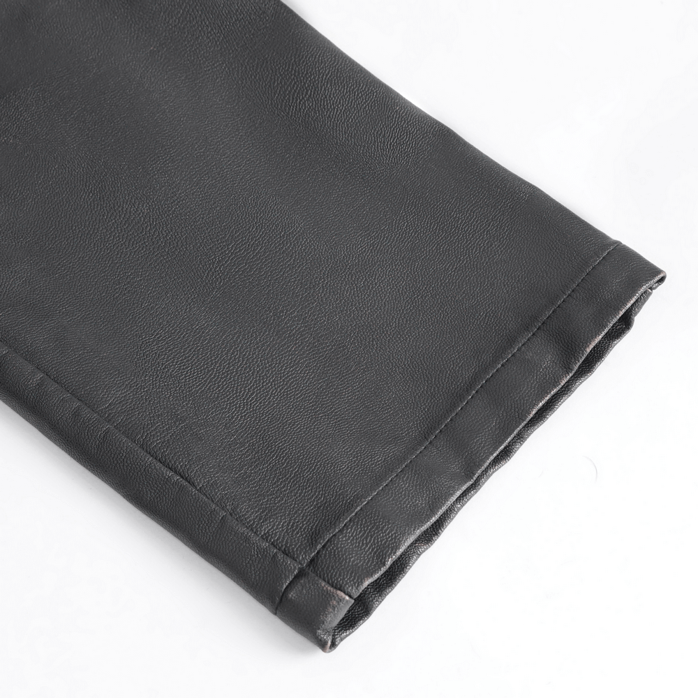 Close-up of the hem of men's Gothic punk faux leather pants with a sleek black finish.