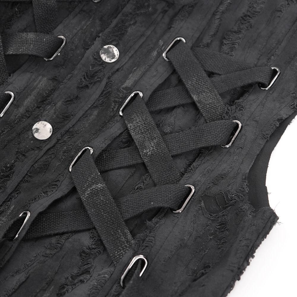 Close-up of men's gothic punk sleeveless shirt featuring lace-up design and metal ring details on textured fabric.