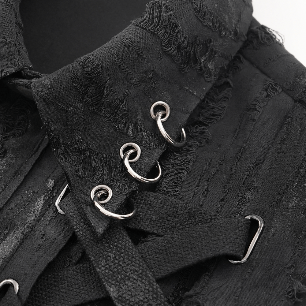 Close-up of a black gothic punk sleeveless shirt featuring lace-up design and metal ring details.