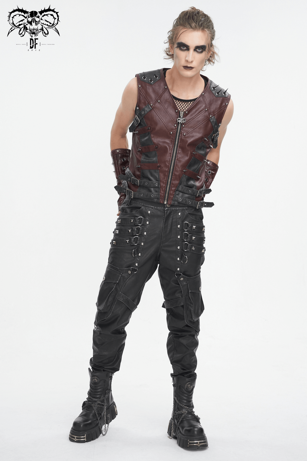 Men's gothic punk studded faux leather vest with zip front, styled with black trousers and edgy accessories.