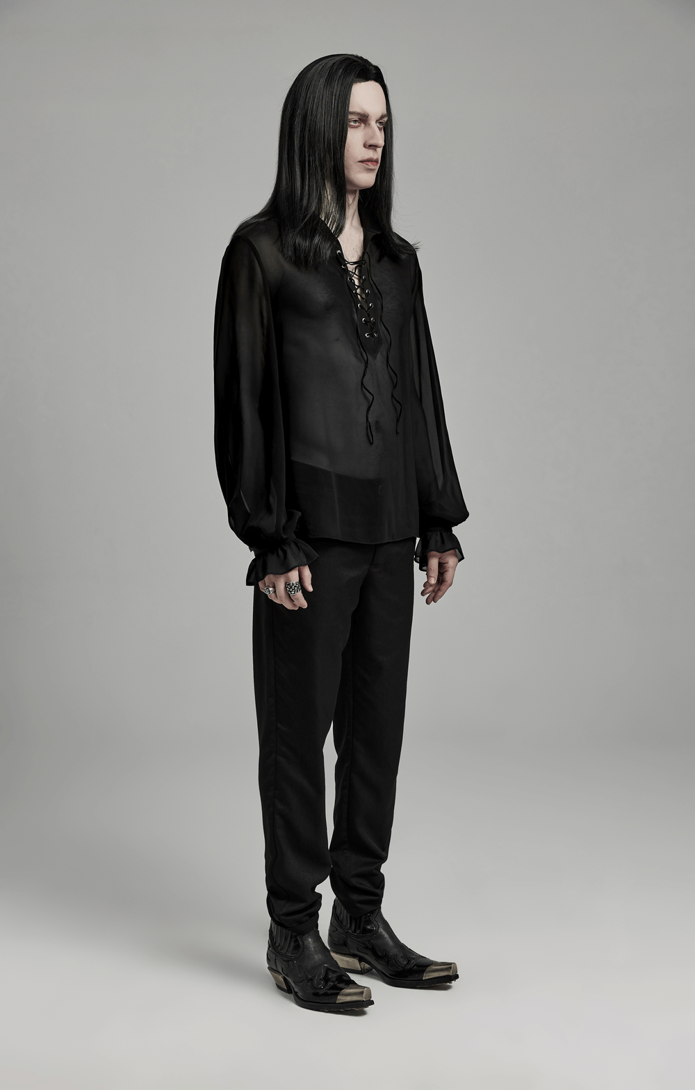 Men's gothic sheer chiffon shirt with lace-up front, paired with black trousers and pointed boots.