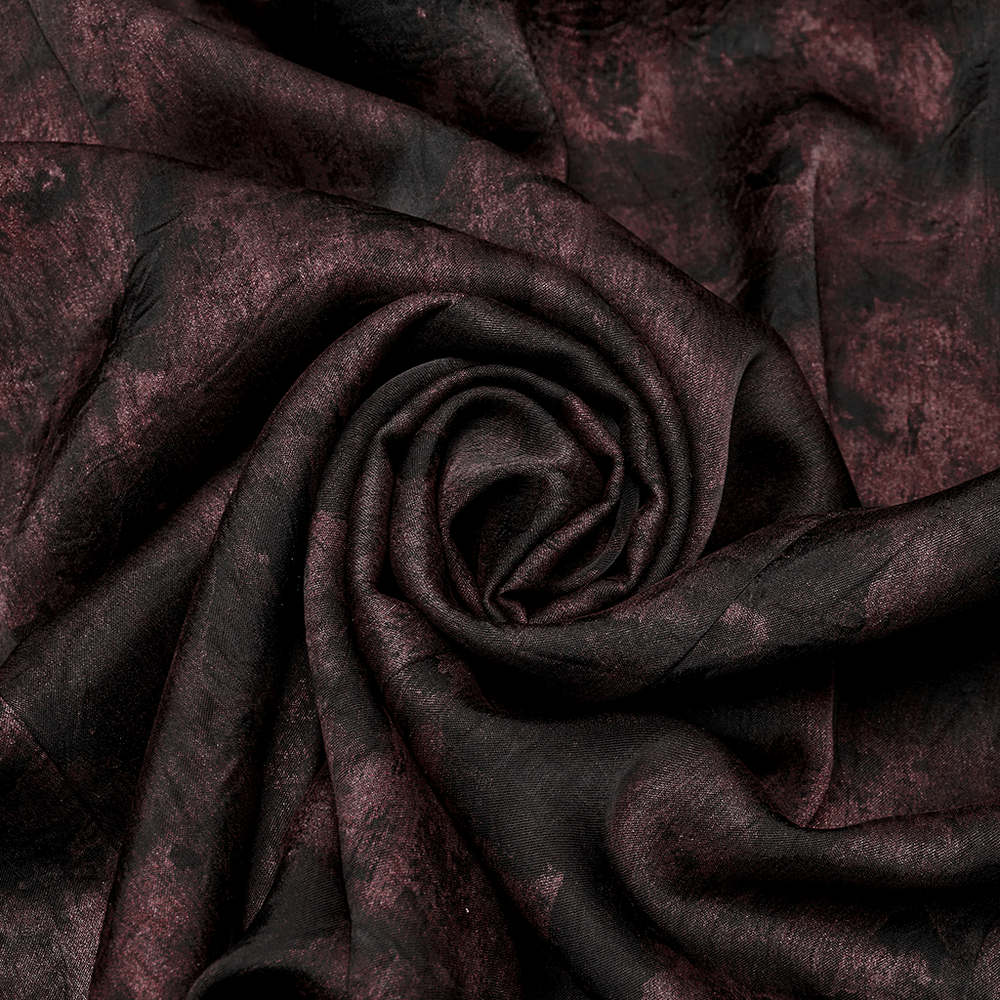 Close-up of smooth woven fabric in dark red and black vintage pattern, perfect for gothic style clothing.