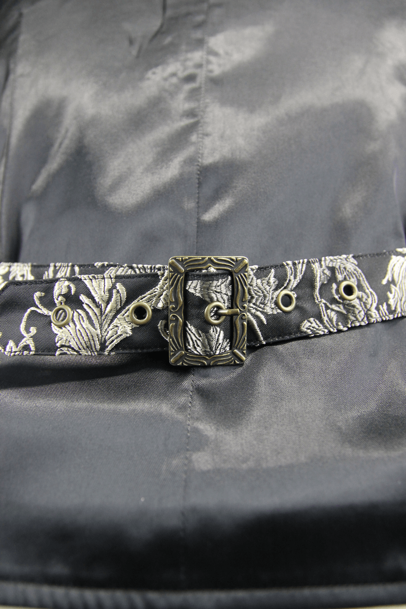 Close-up of a stylish belt with intricate silver floral embroidery, perfect for adding vintage flair to any outfit.