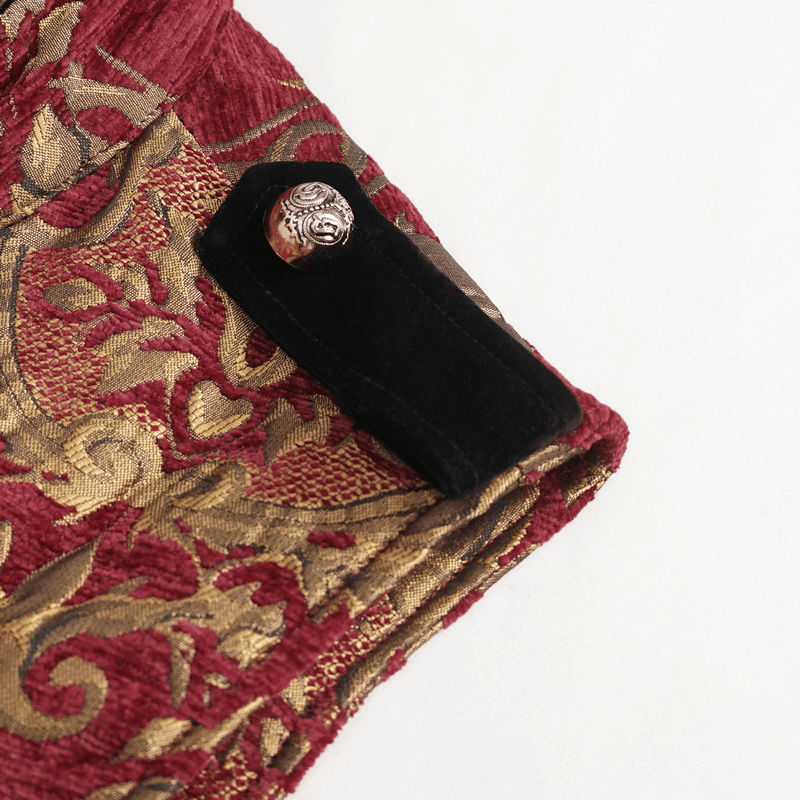 Close-up of the ornate red and gold fabric with a velvet clasp on the men's gothic sleeveless coat.