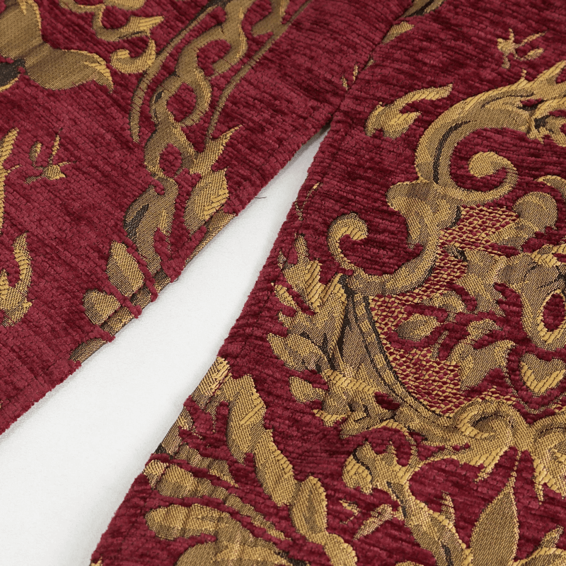 Close-up of ornate gold embroidery on deep red fabric, showcasing vintage gothic coat design details.