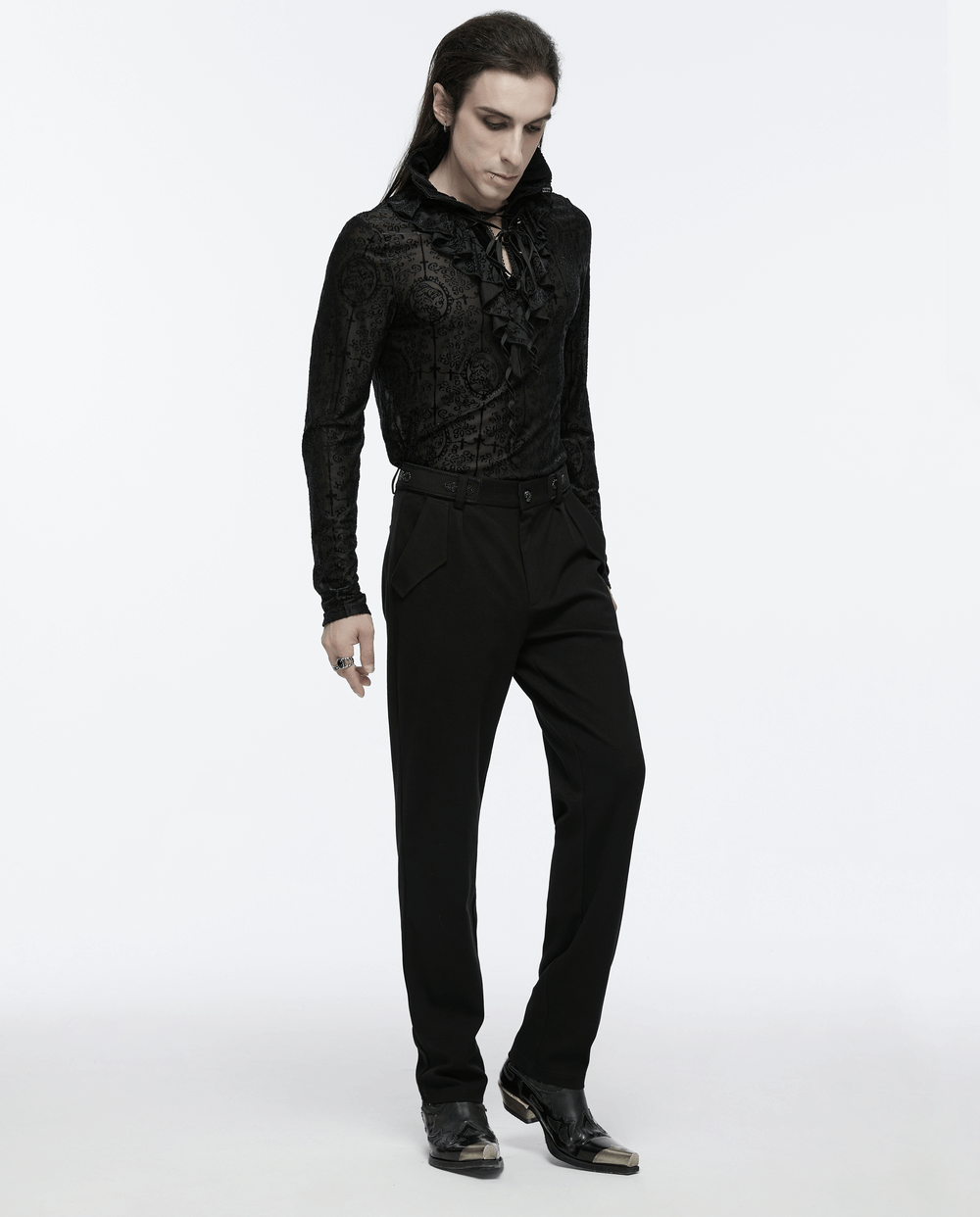 Model in gothic black blouse and straight-leg trousers, showcasing retro buckles and a minimalist style.