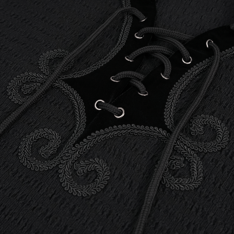 Close-up of black gothic strappy shirt showcasing intricate lace-up detailing and ornate embroidery.
