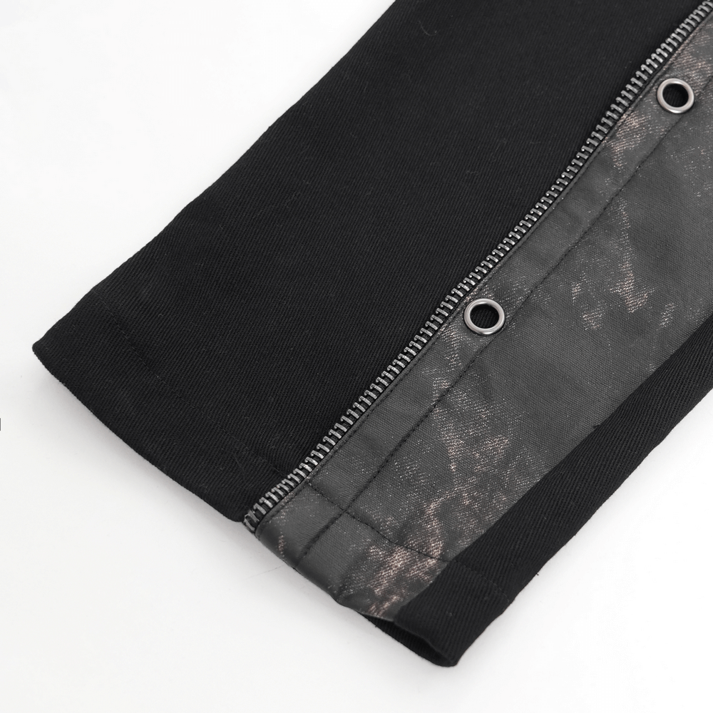 Close-up of gothic techwear pants with distressed faux leather panels and metal rivets, showcasing industrial punk design.