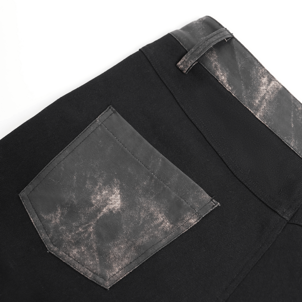 Close-up of men’s gothic techwear pants showing distressed faux leather panel and pocket.