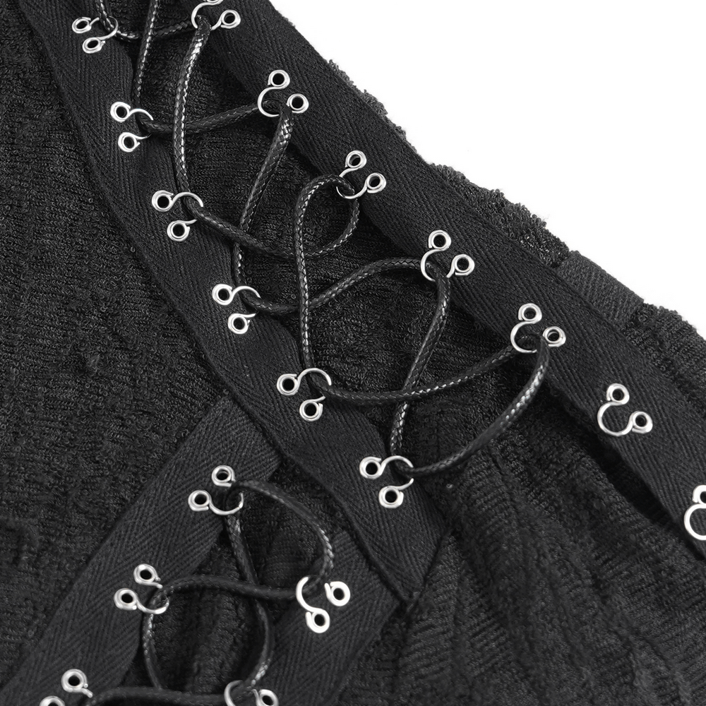 Close-up of intricate corset-style lacing detail on a black mesh gothic top with cut-out sleeves.