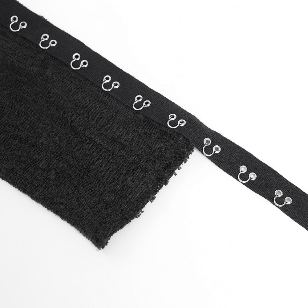 Close-up of black fabric with silver corset hooks, ideal for gothic and punk fashion accessories.