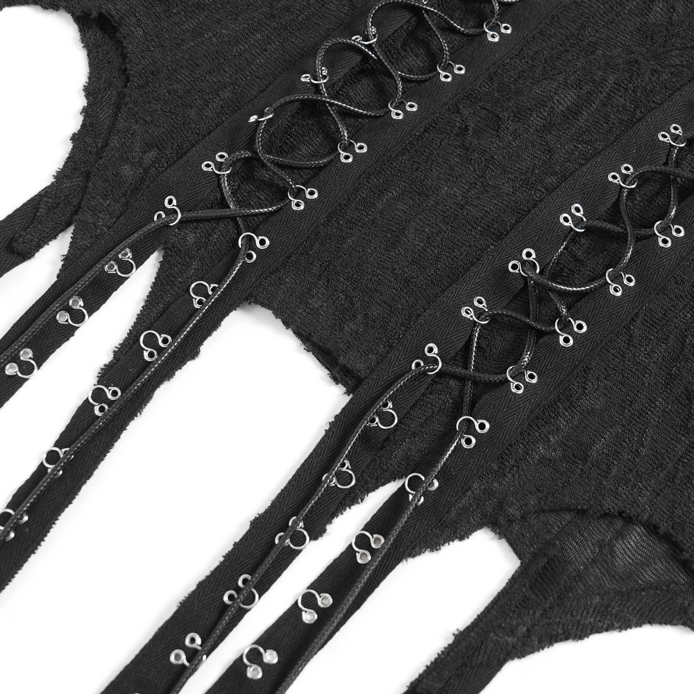 Close-up of black gothic top featuring cut-out sleeves and corset-style lacing detail.