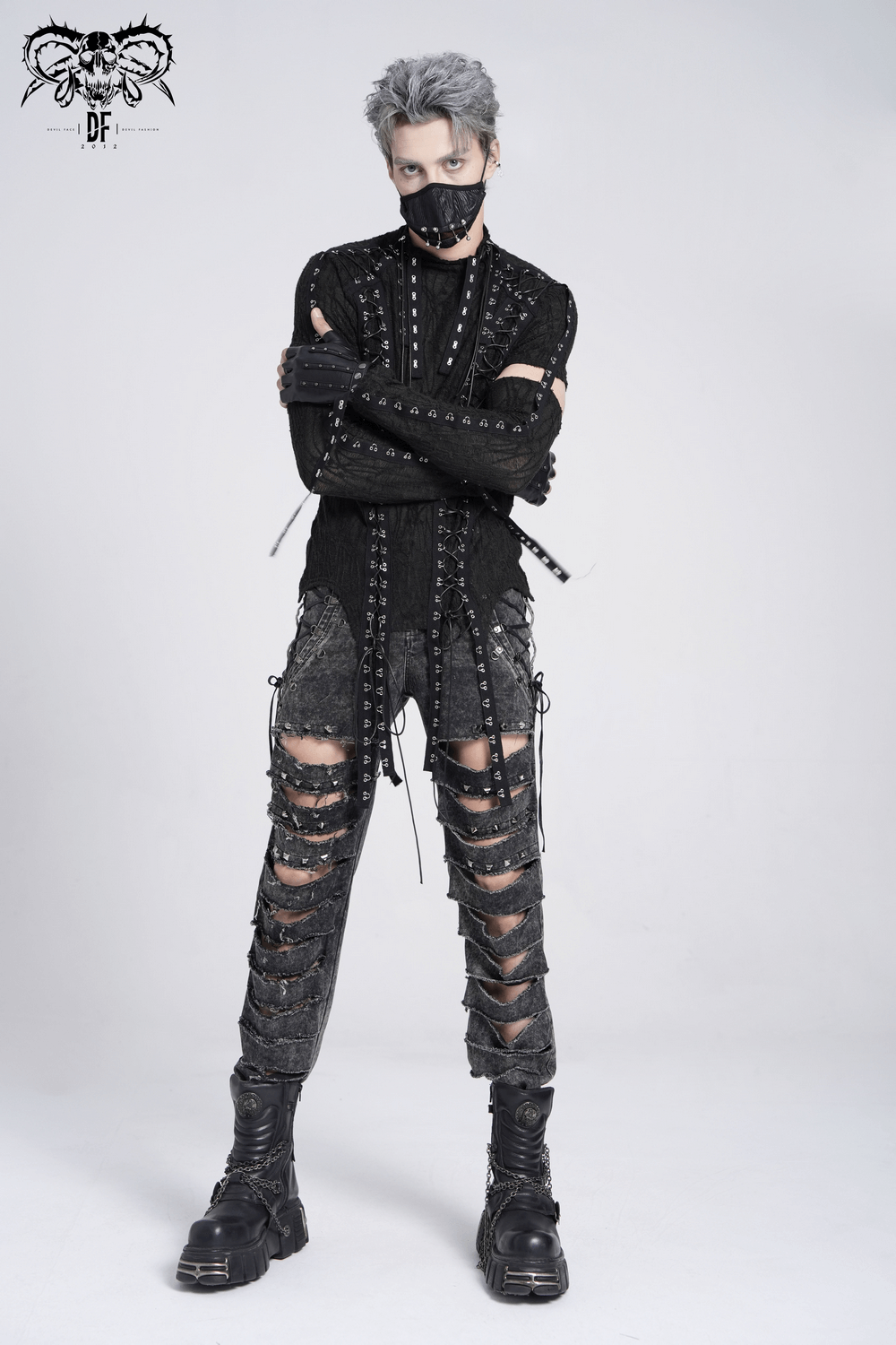 Men's black gothic top with cut-out sleeves, lacing detail, and layered punk-inspired pants, perfect for alternative fashion.