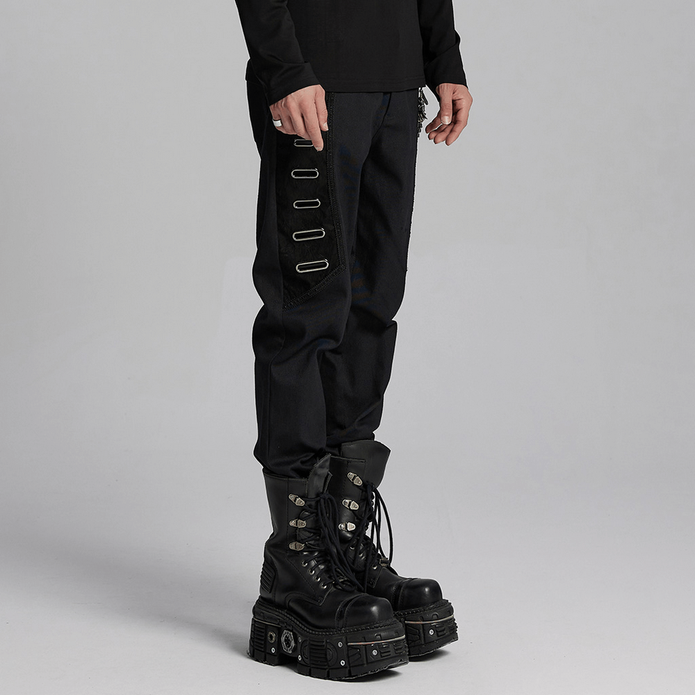 Men's gothic twill pants with eyelet embellishments, paired with chunky black boots for a punk street style look.