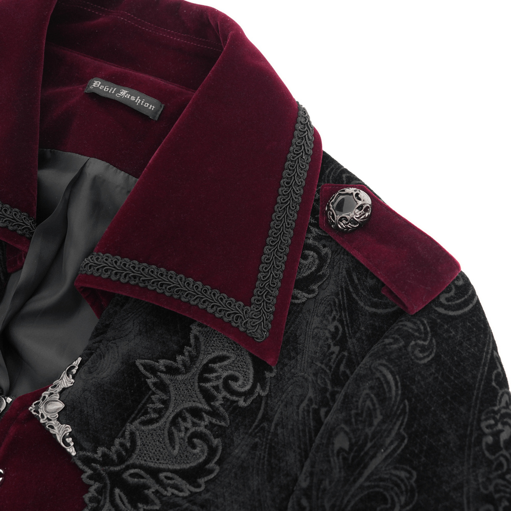Close-up of men's gothic velvet coat with wine red trim, brocade details, and ornate silver-tone buttons.