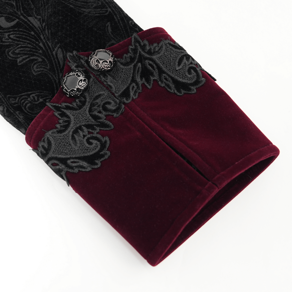 Close-up of gothic velvet coat sleeve with wine red trim and ornate brocade detailing, featuring silver-tone buttons.