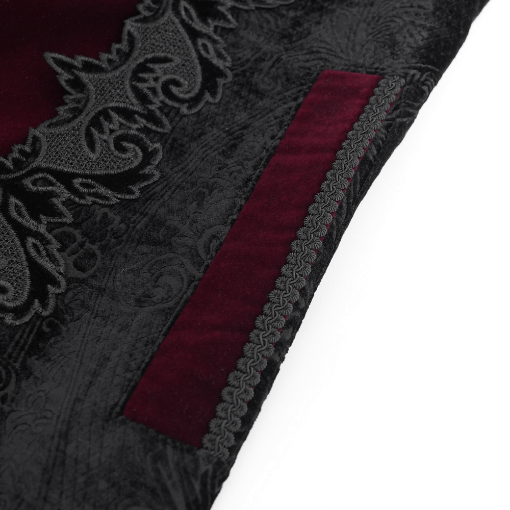 Close-up of gothic velvet fabric with wine red trim and ornate brocade detailing for a Victorian-style coat.