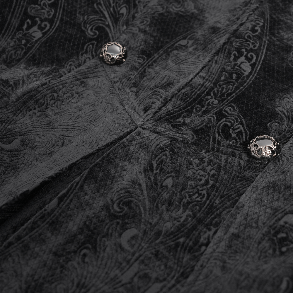 Close-up of luxurious gothic velvet coat with brocade pattern and silver-tone buttons.