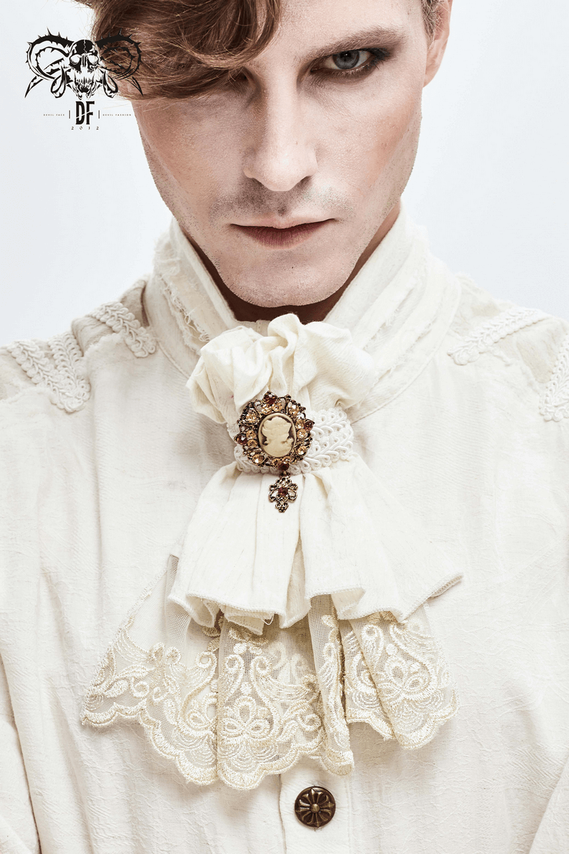 Elegant gothic man wearing a vintage white tie with lace and brooch, showcasing alternative fashion style.