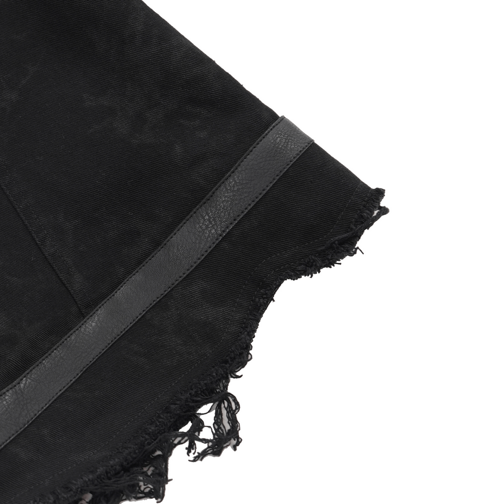 close-up of the frayed edges and leather detail on a men's gothic zipper vest for a punk rock style.