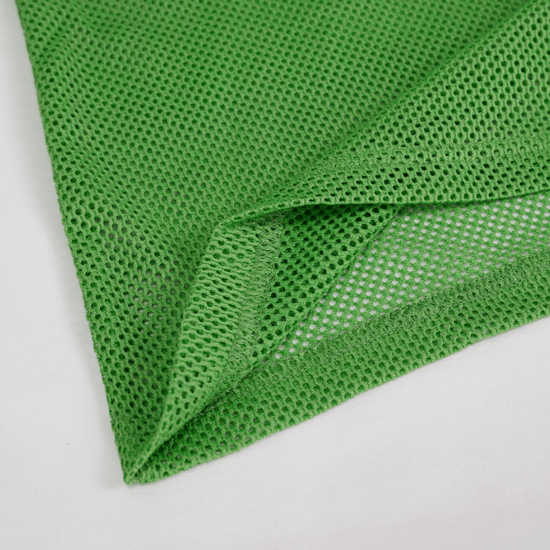 Close-up of breathable green mesh fabric, perfect for alternative style men's long sleeve tops.