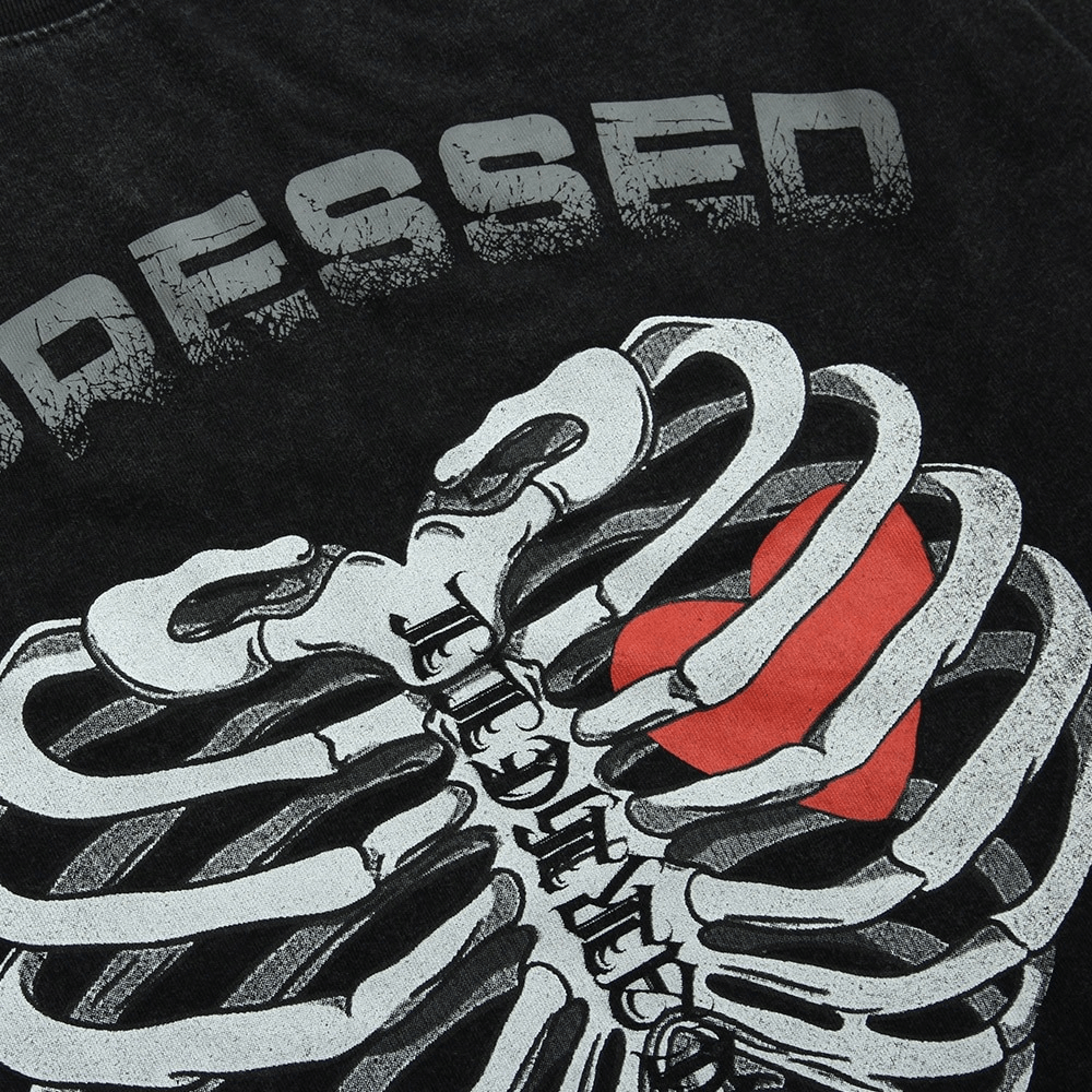 Close-up of men's sweatshirt featuring a skeleton print with a heart, embodying punk style fashion.