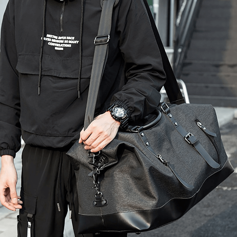 Stylish man holding a large capacity multifunctional travel duffel bag for casual outings and travel.