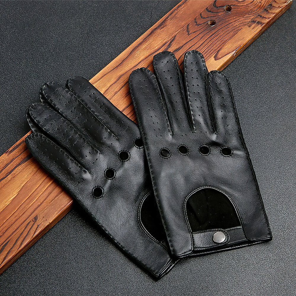 Men's black genuine leather motorcycle riding gloves with full fingers, stylish biker accessory on wood surface.