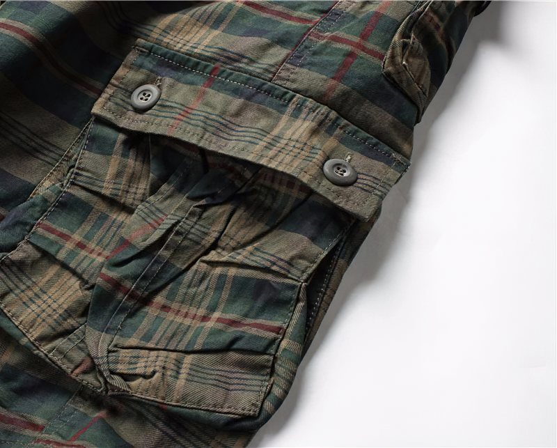 Close-up of men's plaid cargo shorts with detailed pockets and buttons, showcasing casual military style.