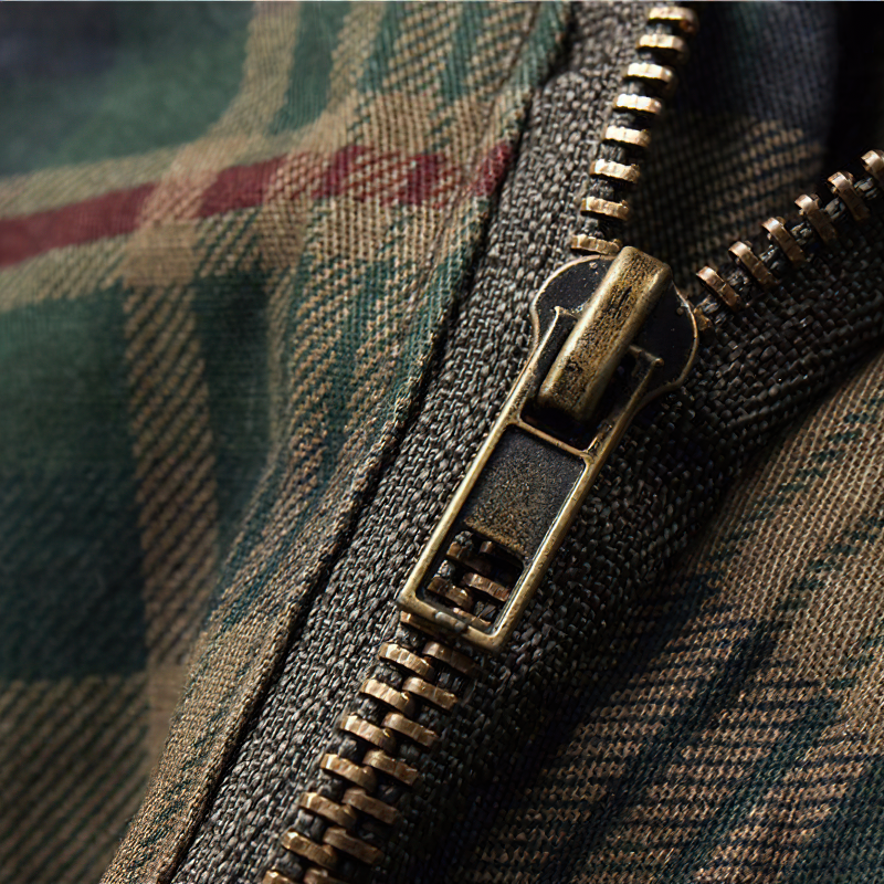 Close-up of men's plaid cargo shorts zipper showing stylish design and quality craftsmanship.