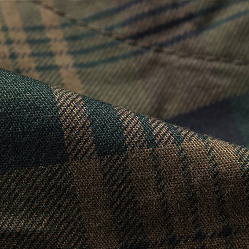Close-up of stylish plaid fabric for men's cargo shorts, featuring earthy tones and classic check patterns.