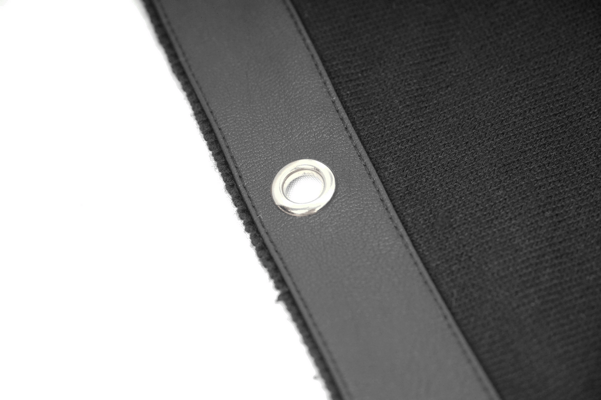 Close-up of lace-up detail on a men's punk hoodie, showcasing metal eyelet and black knit fabric.