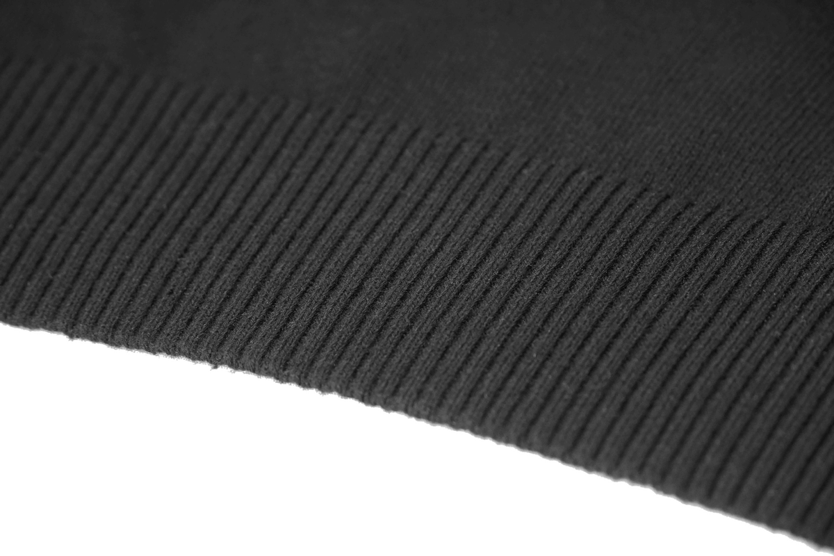 Close-up of the ribbed hem of a black men's punk style hoodie, showcasing its soft texture and comfortable design.