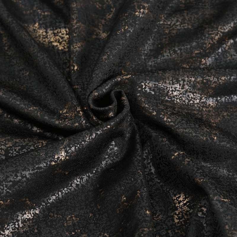 Close-up of black fabric with metallic shimmer, perfect for punk-style clothing designs.