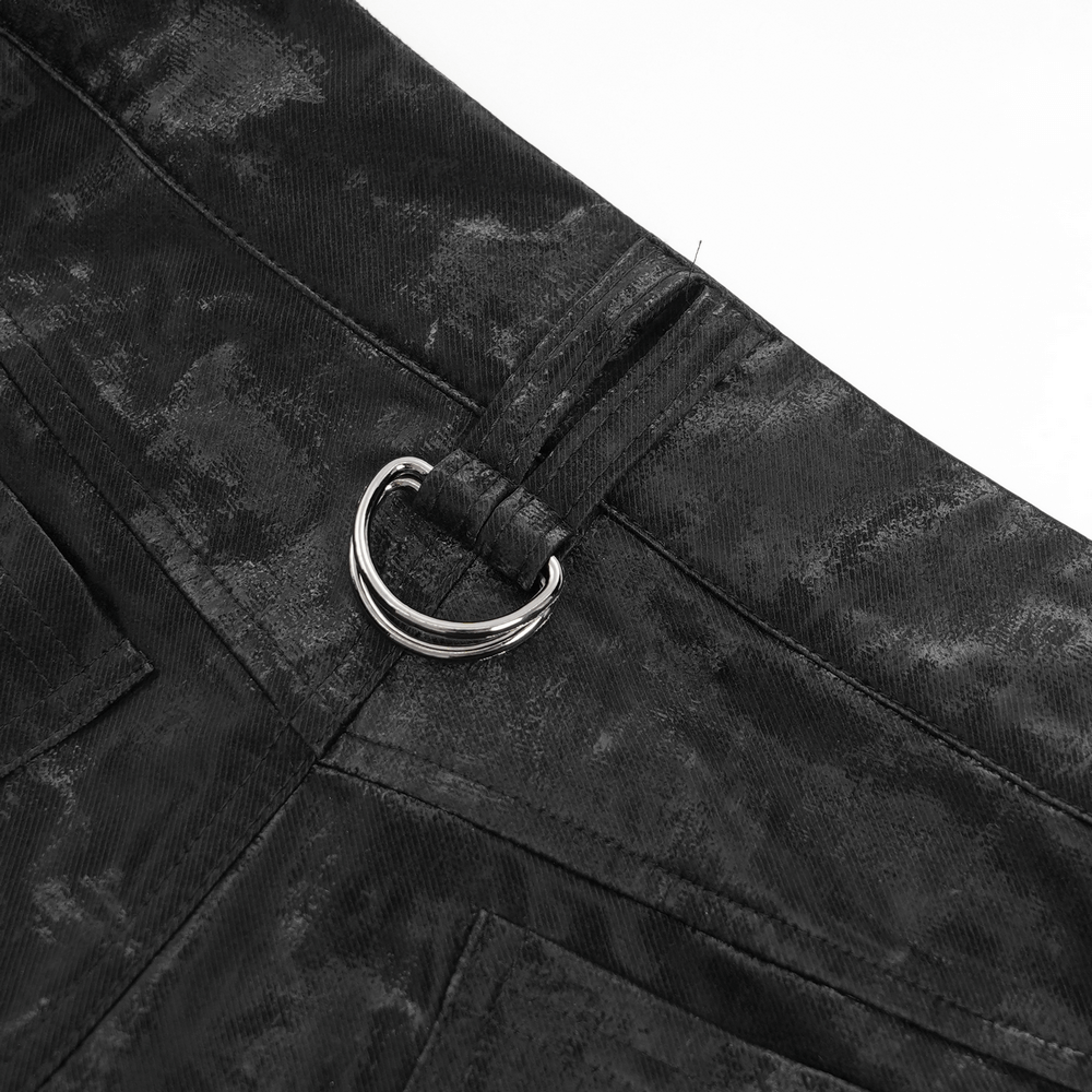 Close-up of metallic buckle and strap detail on men's punk black trousers, showcasing edgy fashion design.