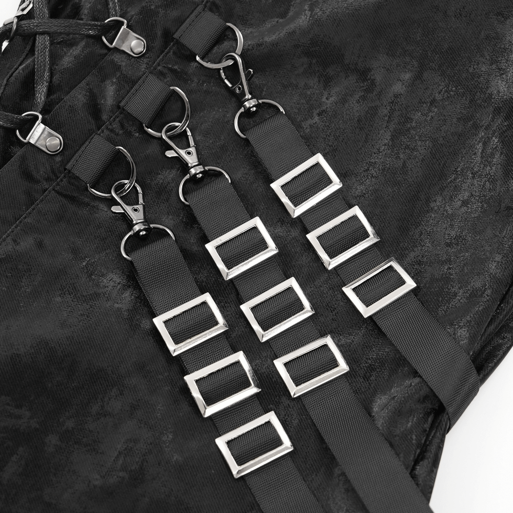 Close-up of adjustable straps with metallic buckles on black punk trousers, showcasing edgy streetwear design.