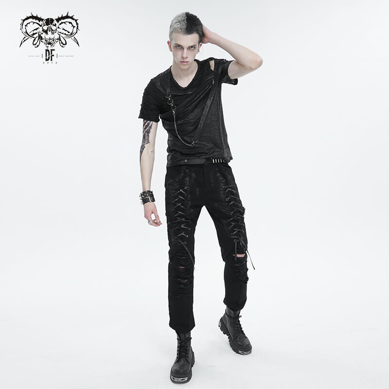 Fashionable men's punk outfit featuring a black cutout t-shirt and distressed pants for a bold, edgy look.