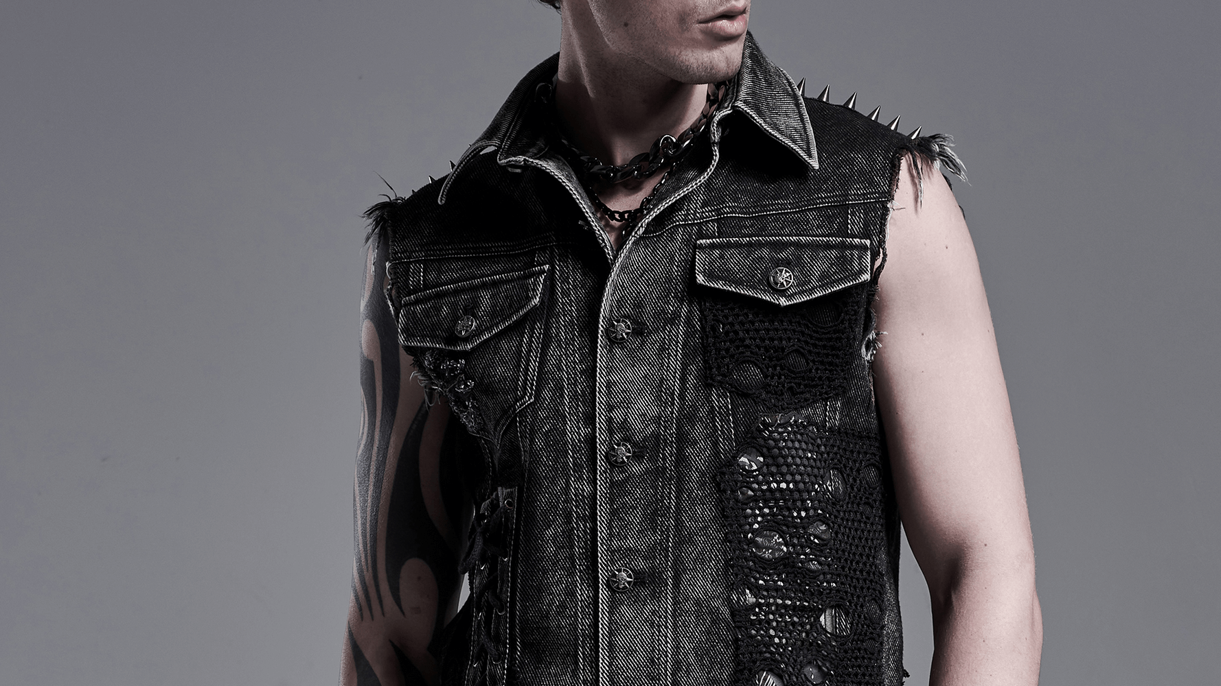 Men's punk denim vest featuring rivets, patches, and a rugged design, perfect for showcasing rebellious style.