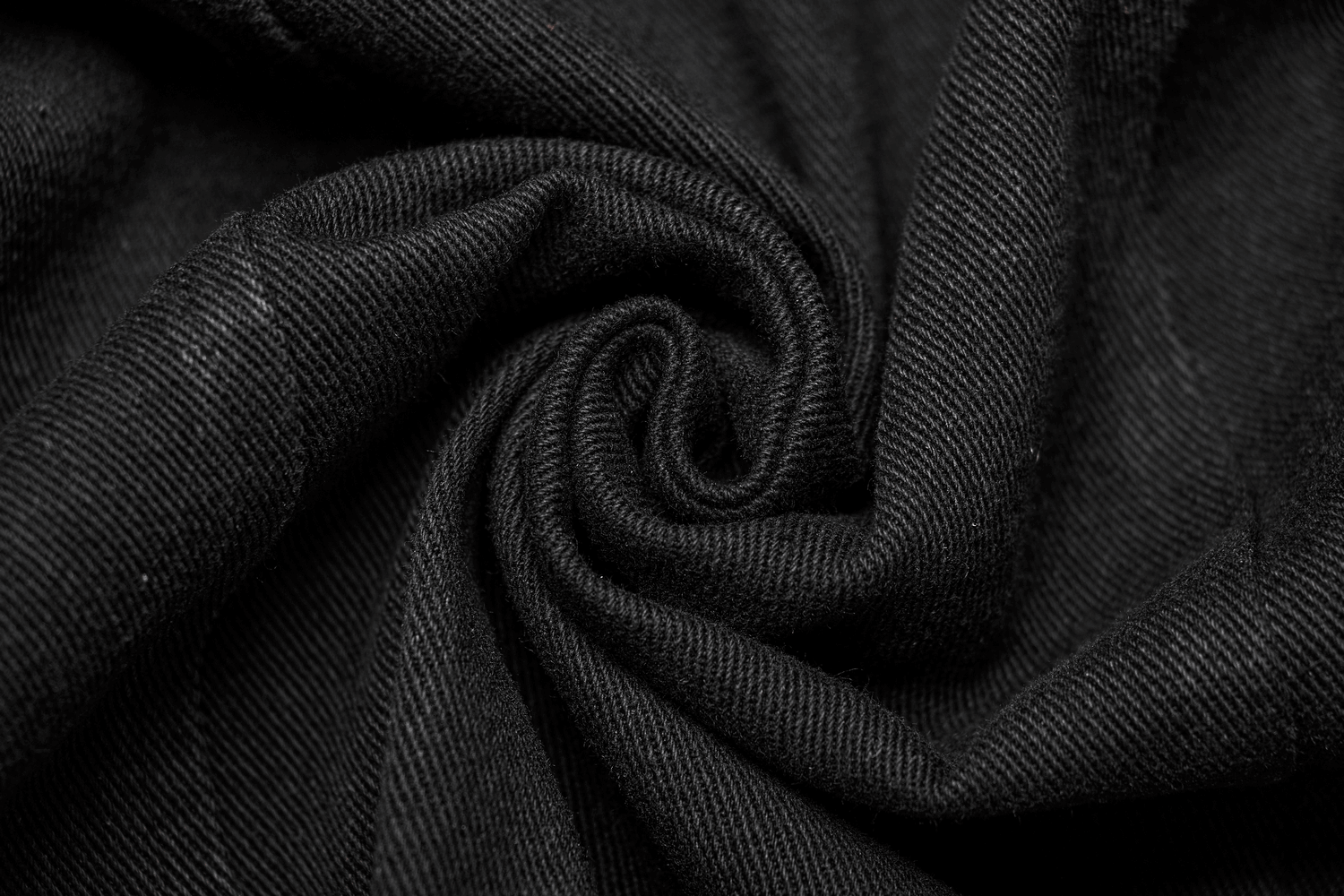 Close-up of black distressed denim fabric, perfect for a punk long vest with a gothic style.