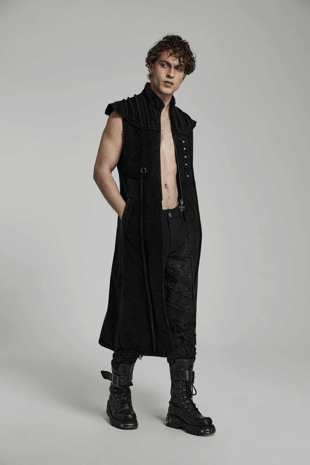 Men's black distressed long denim vest with rivets, showcasing gothic punk style and a post-apocalyptic vibe.