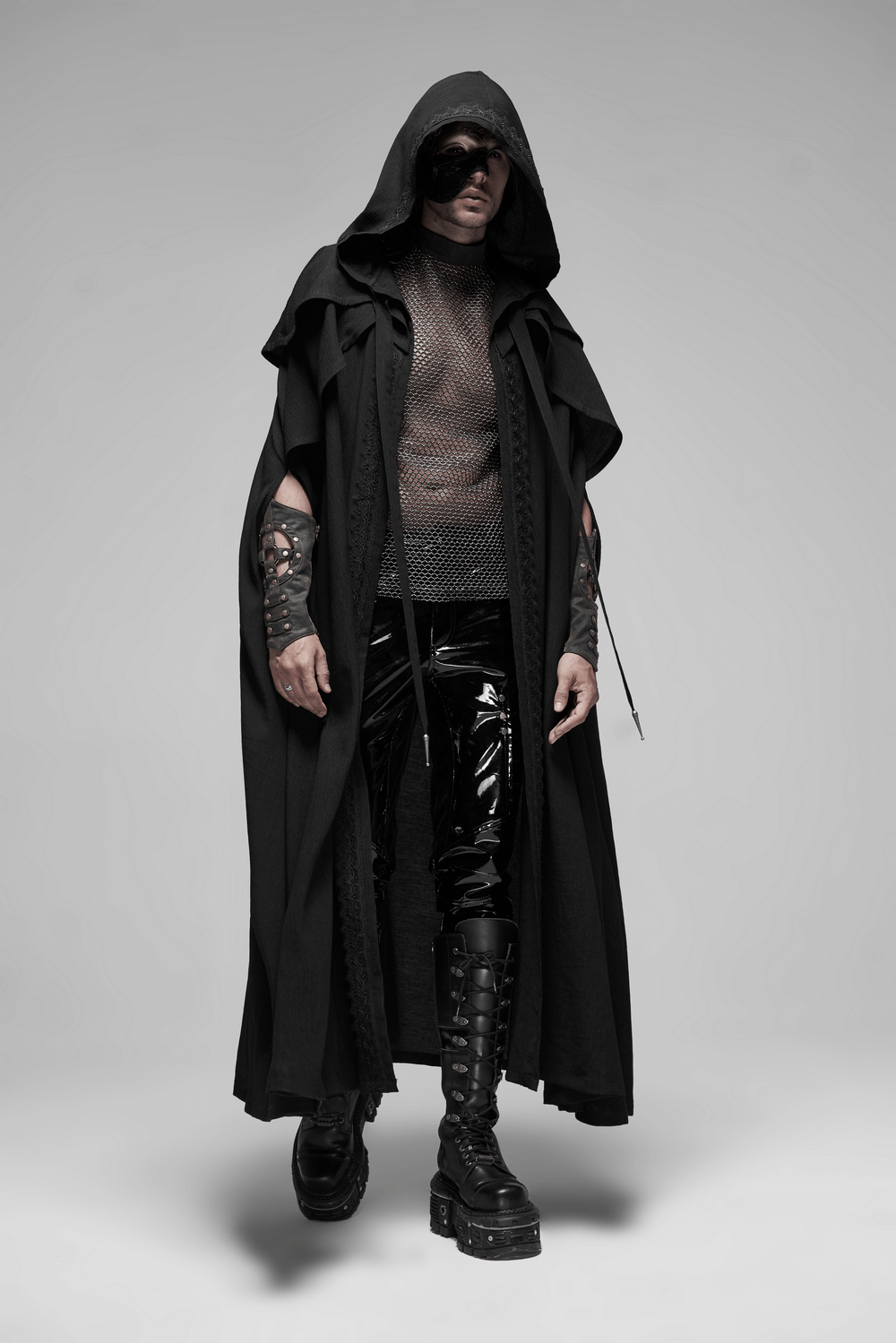 Edgy men's fashion featuring a punk mesh top, hooded cape, glossy pants, and stylish combat boots.