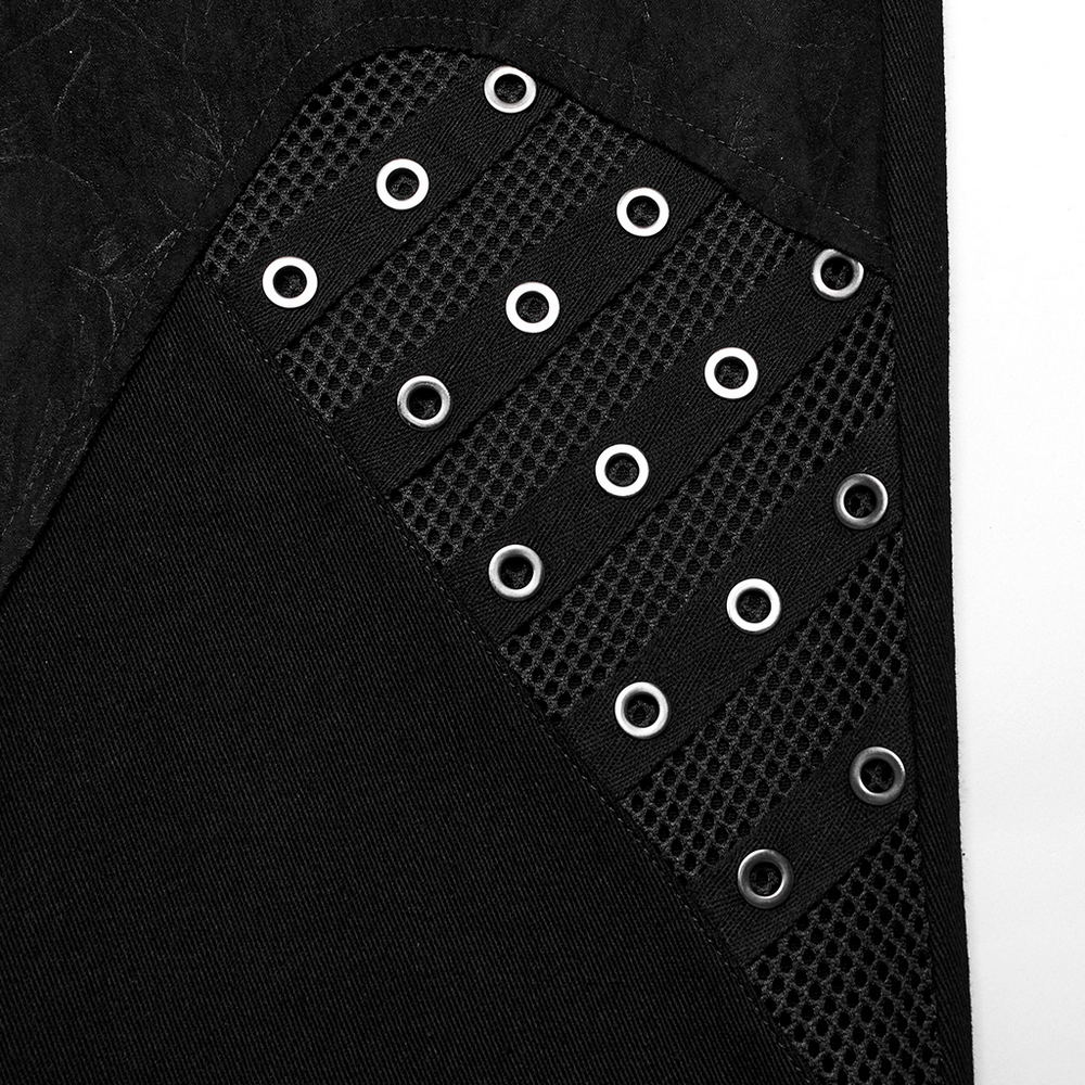 Close-up of men's punk-style pants featuring eyelet and mesh details, showcasing a textured black fabric design.