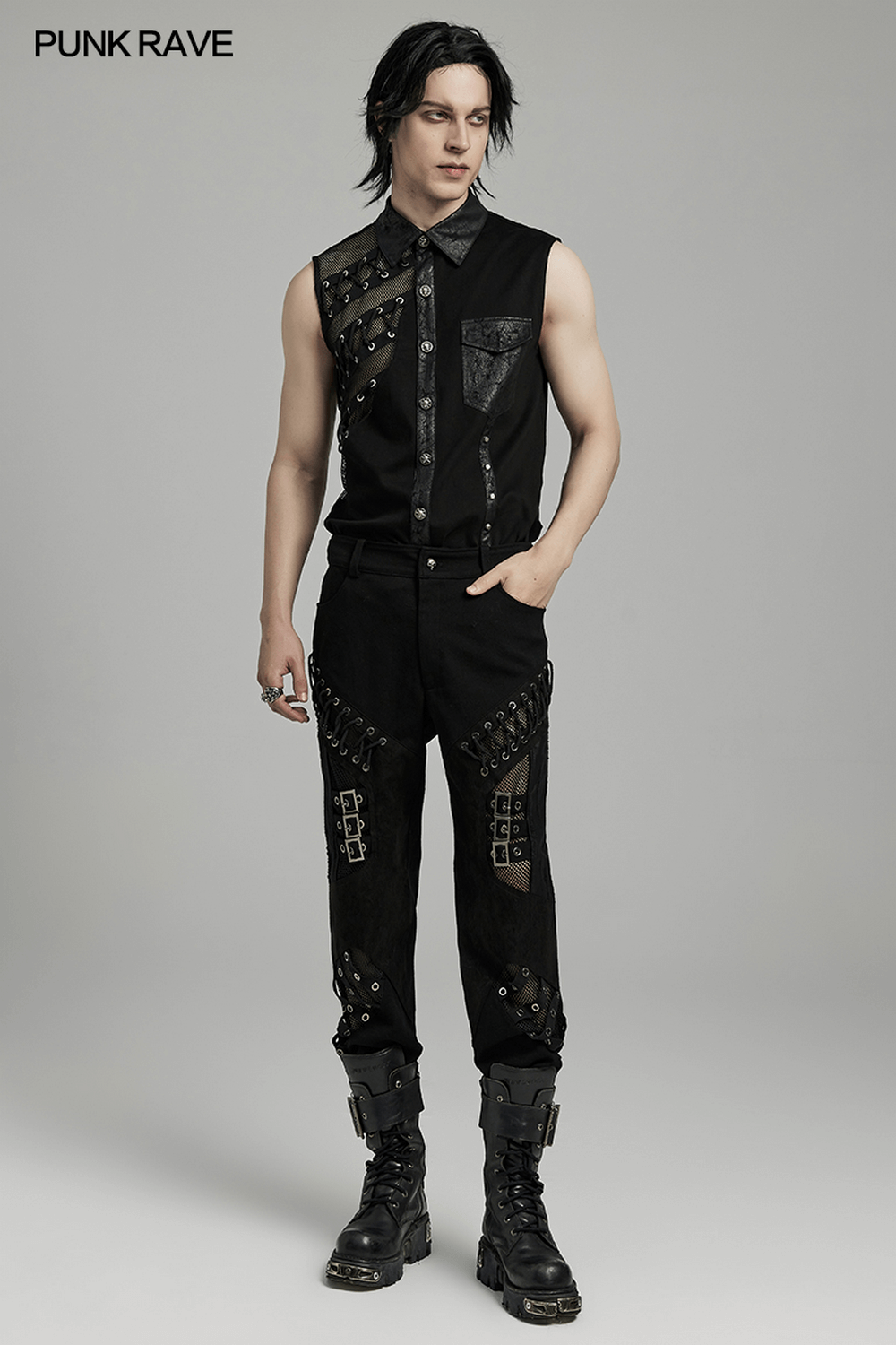 Men's punk style sleeveless shirt with laced black pants and eyelet details, perfect for edgy fashion lovers.