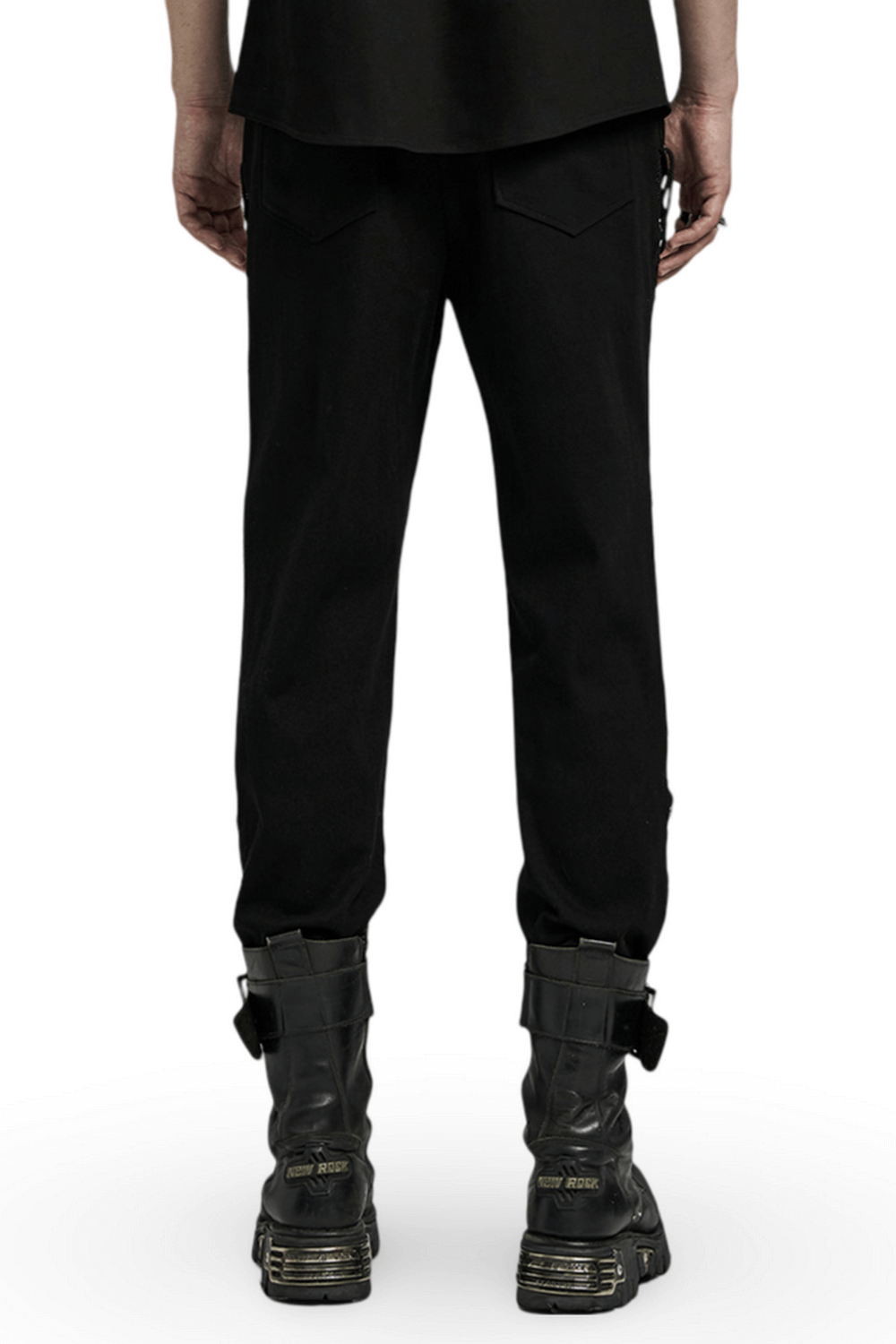 Back view of men's punk style black laced and buckled pants with textured details and combat boots.