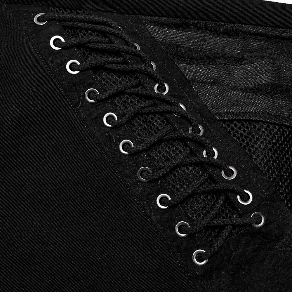Close-up of men's punk style black pants featuring stylish lace-up detail and mesh inserts for a bold look.