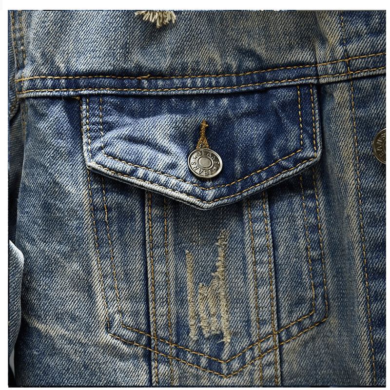 Close-up of a men's ripped denim jacket pocket, showcasing vintage style and distressed details.
